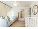 Spacious Bedroom with crib, daybed, plush rug and a giraffe toy at 1486 Brooklyn Nw Ave, Atlanta, GA 30309