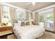 Bright bedroom featuring neutral decor, French doors, and a ceiling fan at 1486 Brooklyn Nw Ave, Atlanta, GA 30309