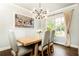 Bright dining room with modern chandelier, wood table, and neutral decor at 1486 Brooklyn Nw Ave, Atlanta, GA 30309