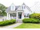 Charming two-story white home with black shutters, covered porch, and landscaped front yard at 1486 Brooklyn Nw Ave, Atlanta, GA 30309