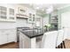 Kitchen view with stainless steel appliances, island with seating, and white cabinets at 1486 Brooklyn Nw Ave, Atlanta, GA 30309