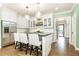 Eat-in kitchen boasts white cabinets, stainless steel appliances, and a stylish island with seating at 1486 Brooklyn Nw Ave, Atlanta, GA 30309