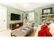 Inviting living room with light green walls, built-in bookshelves, and a large flat screen TV at 1486 Brooklyn Nw Ave, Atlanta, GA 30309