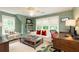 Inviting living room with light green walls, built-in bookshelves, and bright windows at 1486 Brooklyn Nw Ave, Atlanta, GA 30309