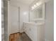 Bathroom featuring a vanity with drawers, a white framed mirror and light fixture at 2610 Cumberland Ct, Smyrna, GA 30080