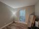 Neutral-toned bedroom featuring hard surface flooring, a window, and natural light at 2610 Cumberland Ct, Smyrna, GA 30080
