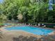 Community pool with lounge chairs and tables, perfect for relaxing and enjoying the outdoors at 2610 Cumberland Ct, Smyrna, GA 30080