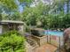 Community pool area with steps, lounging chairs, and a warning sign at 2610 Cumberland Ct, Smyrna, GA 30080