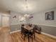 Dining room with marble table, four chairs, light fixture, and hardwood floors at 2610 Cumberland Ct, Smyrna, GA 30080