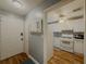 Inviting entryway leads into a kitchen with white appliances, cabinets, and backsplash tiling at 2610 Cumberland Ct, Smyrna, GA 30080