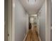 Hallway featuring a overhead light fixture, wooden floors, and multiple doors at 2610 Cumberland Ct, Smyrna, GA 30080