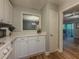 Bright kitchen featuring white cabinets, countertops, and a pass-through to the adjacent living area at 2610 Cumberland Ct, Smyrna, GA 30080