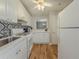 Efficient kitchen layout features white appliances, modern cabinets, and a lovely tile backsplash at 2610 Cumberland Ct, Smyrna, GA 30080