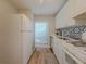 Well-lit kitchen featuring a window, sleek white appliances, and stylish backsplash over the countertop at 2610 Cumberland Ct, Smyrna, GA 30080