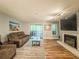 Comfortable living room features a fireplace, sliding door to balcony, and plush seating for relaxation at 2610 Cumberland Ct, Smyrna, GA 30080