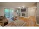 Bright living room featuring a sliding glass door to a balcony, a fireplace, and hardwood floors at 2610 Cumberland Ct, Smyrna, GA 30080