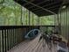 View of an outdoor deck with chairs and a kayak overlooking lush trees at 2610 Cumberland Ct, Smyrna, GA 30080