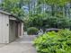 Pool restrooms and outdoor shower with landscaping, and a glimpse of the pool in the background at 2610 Cumberland Ct, Smyrna, GA 30080