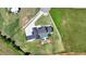 Overhead view of a house with a pool, expansive lawn, a fire pit area, and a large driveway at 5160 Howard Rd, Cumming, GA 30040