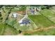 Drone view of a house with a pool, large backyard, a fire pit, a huge drive, and lush greenery surrounding the property at 5160 Howard Rd, Cumming, GA 30040