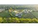 Expansive aerial view of a luxury estate surrounded by lush greenery, showcasing a modern home with a unique, elevated pool at 5160 Howard Rd, Cumming, GA 30040