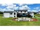 Well-manicured backyard featuring an outdoor pool, deck, and an inviting fire pit and lounge area at 5160 Howard Rd, Cumming, GA 30040