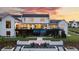 Backyard view showcasing a modern home, pool, fire pit, and landscaped terraces, perfect for entertaining at 5160 Howard Rd, Cumming, GA 30040
