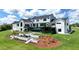 Beautiful backyard showcasing a pool, lounge deck, manicured lawn, and a cozy fire pit and patio area at 5160 Howard Rd, Cumming, GA 30040