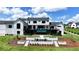 Striking home featuring an outdoor pool, deck, and professionally landscaped backyard and fire pit area at 5160 Howard Rd, Cumming, GA 30040