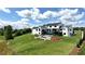 Expansive backyard with a modern pool, entertainment deck, and a stylish fire pit patio for relaxing outdoors at 5160 Howard Rd, Cumming, GA 30040