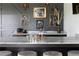 Wet bar boasts a gray countertop, seating, and a dark accent wall adorned with unique artwork at 5160 Howard Rd, Cumming, GA 30040