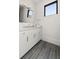 Modern bathroom with white vanity, sleek fixtures, and stylish gray tile flooring at 5160 Howard Rd, Cumming, GA 30040