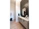 Modern bathroom with a decorative tile wall, floating vanity, and gold accents at 5160 Howard Rd, Cumming, GA 30040