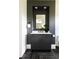 Stylish powder room featuring dark gray walls, herringbone floors, and white countertop sink at 5160 Howard Rd, Cumming, GA 30040