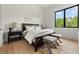 Bedroom with a large bed, hardwood floors, and natural light from the window at 5160 Howard Rd, Cumming, GA 30040