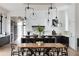 Open-concept dining area with modern table, chairs, and stylish pendant lights at 5160 Howard Rd, Cumming, GA 30040