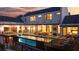 A sleek, cantilevered pool and outdoor entertaining space featuring comfortable seating and inviting outdoor lighting at dusk at 5160 Howard Rd, Cumming, GA 30040