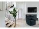 Modern entryway with open staircase, sleek black railings, and stylish decor at 5160 Howard Rd, Cumming, GA 30040