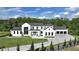 Striking modern farmhouse with black-framed windows, manicured lawn, and a spacious driveway at 5160 Howard Rd, Cumming, GA 30040