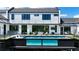 Backyard featuring a pool with glass side, outdoor living space, providing a luxurious outdoor experience at 5160 Howard Rd, Cumming, GA 30040