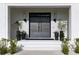 Inviting front entrance with a modern double door, potted plants, and stylish outdoor lighting at 5160 Howard Rd, Cumming, GA 30040