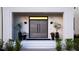 Elegant front entry featuring double doors, stylish sconces, and beautiful potted plants at 5160 Howard Rd, Cumming, GA 30040