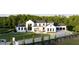 Elegant home featuring a modern design, a spacious driveway, manicured landscaping, and a welcoming entrance at 5160 Howard Rd, Cumming, GA 30040