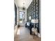 Bright hallway with a decorative wall, modern light fixture, and light wood floors at 5160 Howard Rd, Cumming, GA 30040
