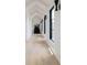 Hallway with hardwood flooring, modern sconces, and vaulted ceilings at 5160 Howard Rd, Cumming, GA 30040