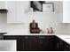 Kitchen featuring white countertops, wood lowers, stainless appliances, and decorative vases at 5160 Howard Rd, Cumming, GA 30040