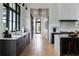 Modern kitchen features white cabinets, dark wood cabinets, a large window, and wooden floors at 5160 Howard Rd, Cumming, GA 30040