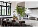 The marble kitchen island is adorned with a vase and has seating for four, complemented by natural light at 5160 Howard Rd, Cumming, GA 30040