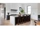 Modern kitchen with white and dark cabinets, a center island with seating, and stainless steel appliances at 5160 Howard Rd, Cumming, GA 30040