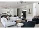 Open-concept living space with modern decor, comfortable seating, and a view into the kitchen at 5160 Howard Rd, Cumming, GA 30040